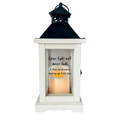 White lantern with a candle inside and a quote on a light gray background