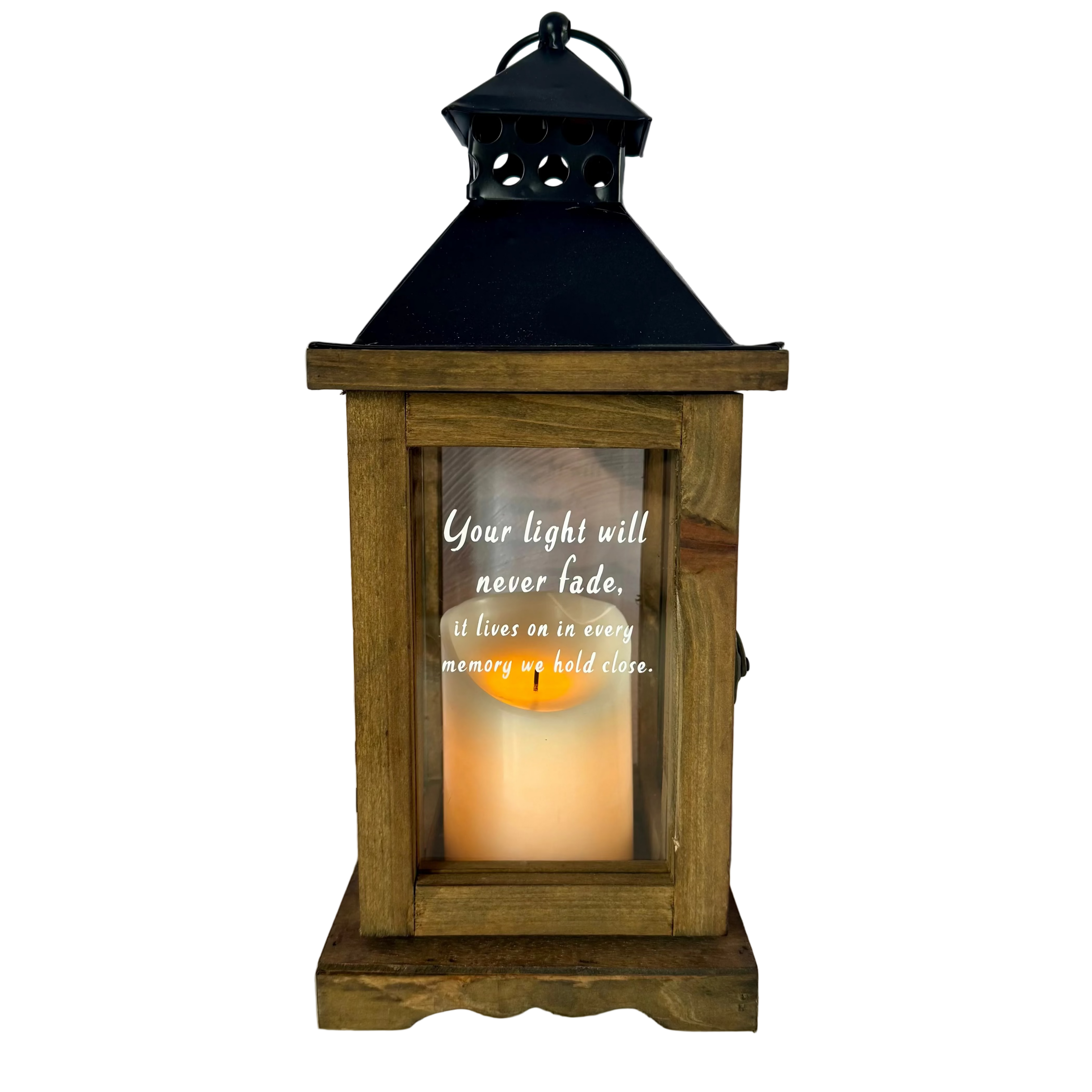 Wooden lantern with a candle inside and an engraved message on a light background