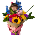Child holding a large bouquet of colorful flowers on a wooden deck.