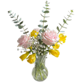 Bouquet of pink and yellow flowers in a clear glass vase on a white background
