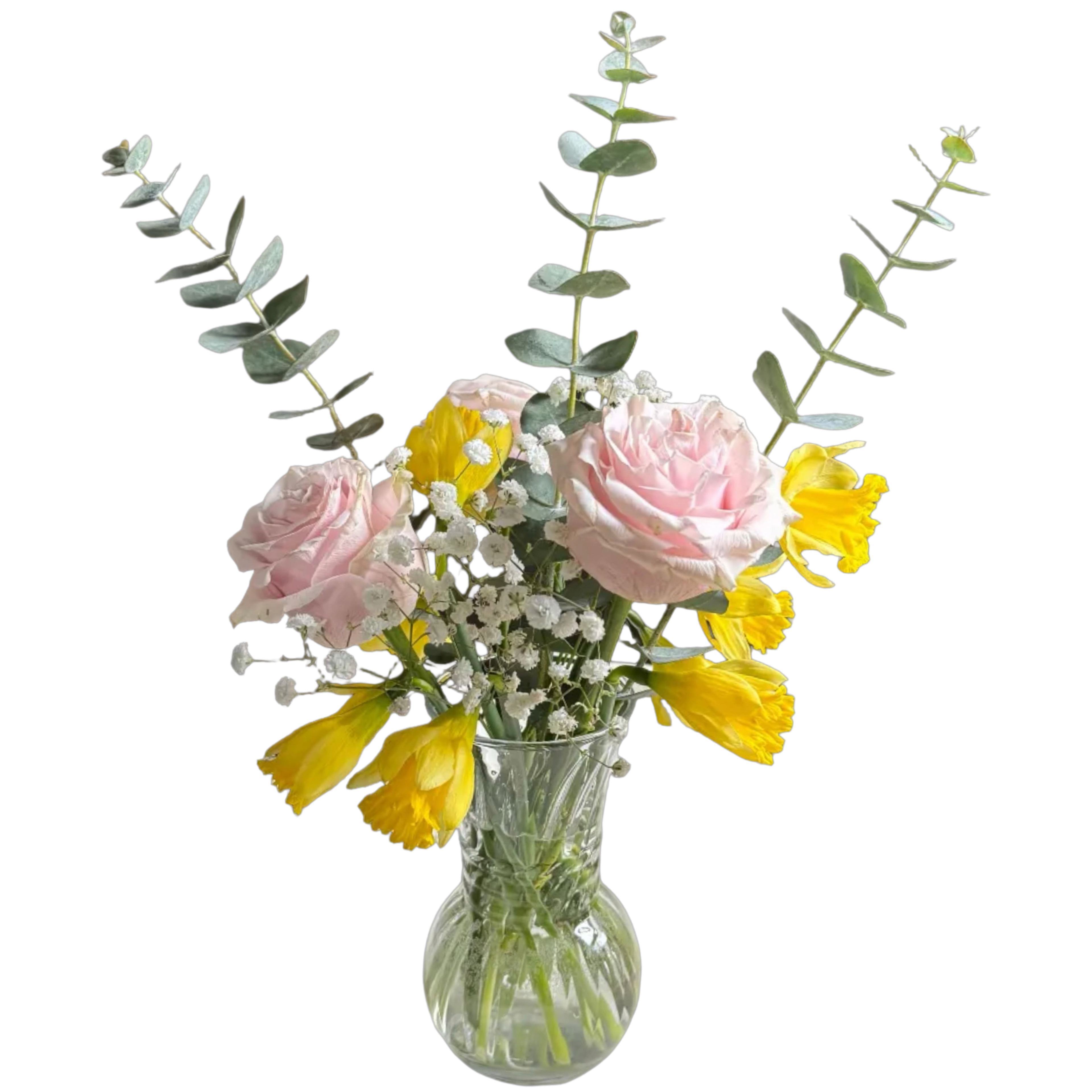 Bouquet of pink and yellow flowers in a clear glass vase on a white background